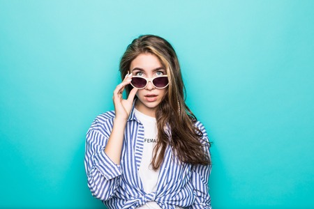 Young woman in casual wear isolated on blue background
