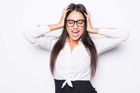 Frustrated and stressed young businesswoman in suit. Beautiful young woman isolated on white background.の写真素材