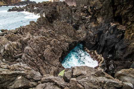 Lava rocks natural volcanic pools in Porto Moniz, Portugal.の写真素材