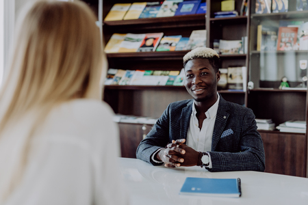 successful african american insurance broker meeting client in officeの写真素材
