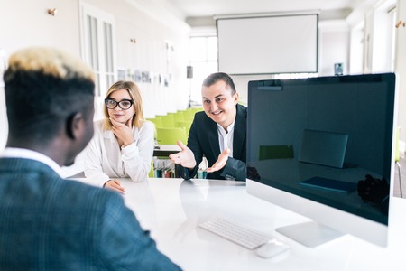 Couple meeting businessman in office