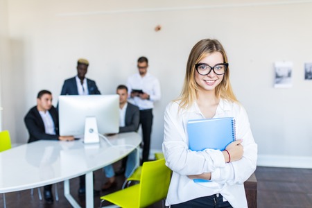 Face of beautiful woman on the background of business peopleの写真素材