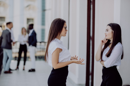 Two bussiness partners man and woman over team backgroundの写真素材