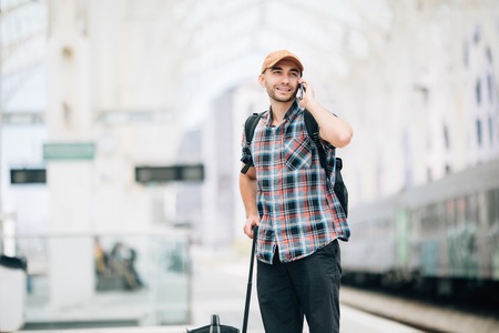 Man talking on the phone at the train stationの写真素材