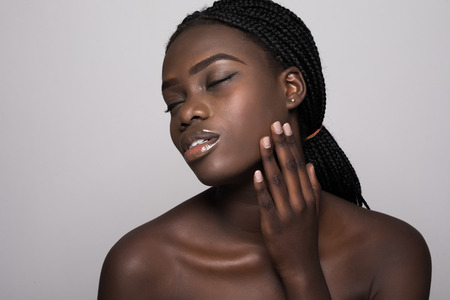 Beauty portrait of a young woman with skin care posing isolated on a white backgroundの写真素材