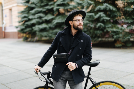 Handsome hipster enjoying city ride by bicycle.の写真素材