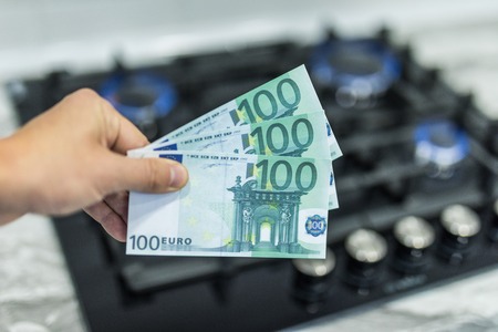 increase in the cost of the gas bill - euro money and gas stove turned on