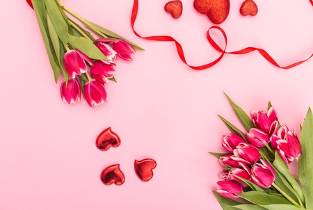 Pink tulips with ribbon and hearts isolated on white background Valentines day conceptの写真素材