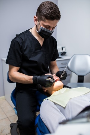 Woman having teeth examined at dentists at clinicの写真素材