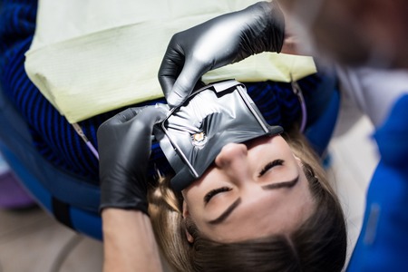 Modern dental equipment. Dentist treats tooth decay in the teeth with a dental drill, saliva...