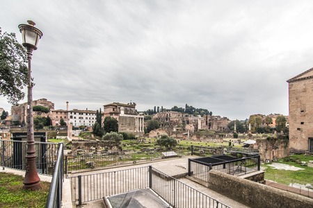 ROME, ITALY - November, 2018: Tourists in the Roman Forum at Temple of Saturn against Arch of Septimius Severus.のeditorial素材