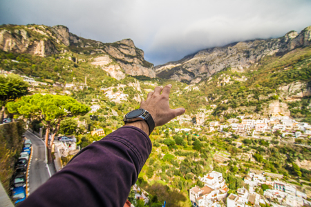 Man hand on view on Positano city in Amalfi coastの写真素材