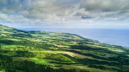 Aerial view on scenic landscape of volcano and green fields around it. Special shape of ground. Azores islands, Sao Miguel, Portugal.の写真素材