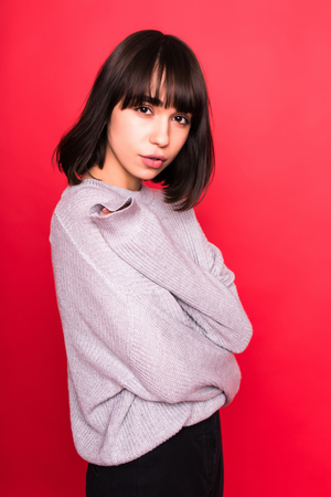 Profile side view photo of fold cross hands over chest person, stand half turn in casual wear isolated on bright red backgroundの写真素材