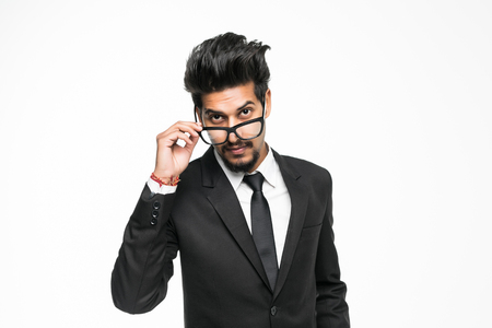 Closeup portrait of handsome young indian businessman isolated on white background. Positive human emotions facial expressions, feelings, attitude perceptionの写真素材