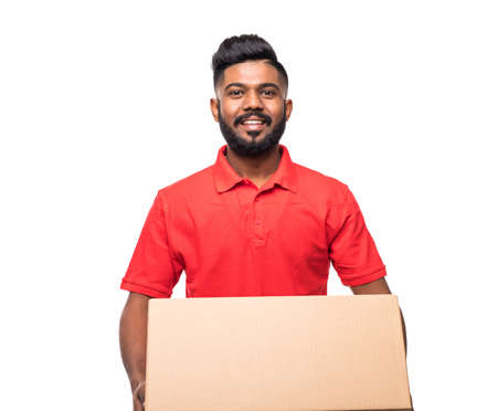 Side view of young delivery man with box. isolated gray backgroundの写真素材