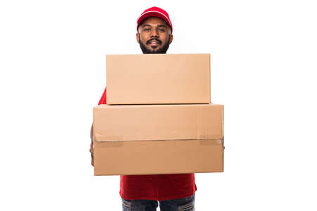 Side view of young delivery man with box. isolated gray backgroundの写真素材