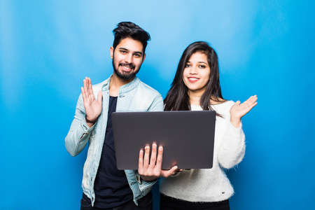 Young indian couple take selfie on green background