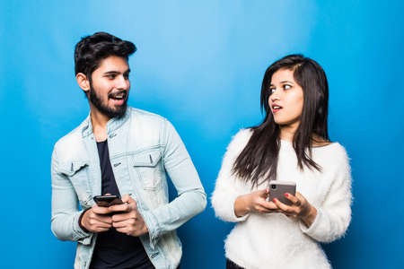 Young indian couple take selfie on green background