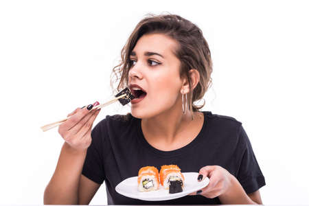 Young girl holding plate of sushi in her hands
