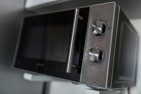 Empty microwave oven with open doorの写真素材
