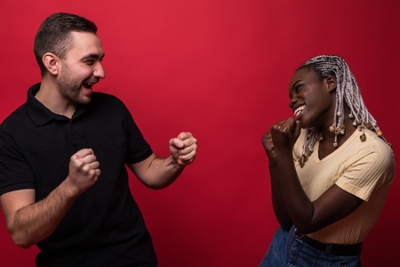 Portrait of man and woman in casual clothes screaming at each other standing face to face isolated...