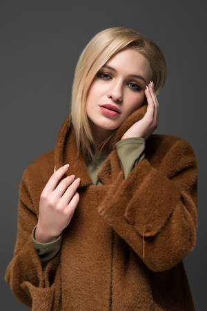 Beauty Fashion brunette model girl wearing stylish coat and sunglasses.の写真素材