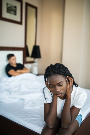 Family conflict with wife and husband in bedの写真素材