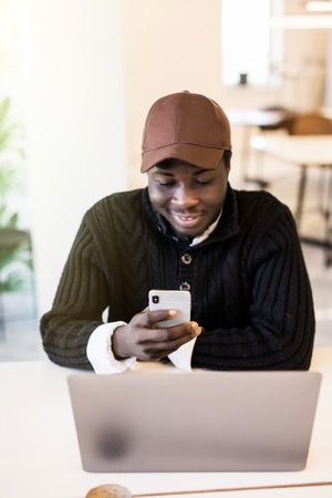 Browsing Afro-American Man on smartphone