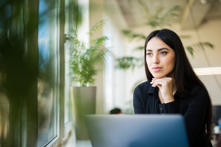 Attractive business woman working on laptop at office.の写真素材