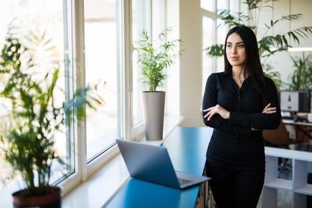 Portrait of successful businesswoman standing at her office.の写真素材