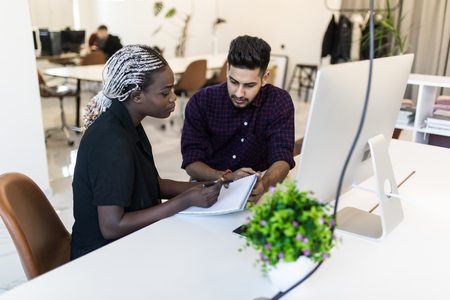 multiracial businesspeople using laptop computer in officeの写真素材