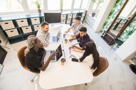 Startup diversity teamwork brainstorming meeting concept. Business young multiethnic team working and planning Start Up in modern officeの写真素材