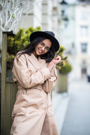 fashion style portrait of young trendy girl walking along the streetの写真素材
