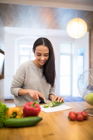 Young Woman Cooking. Healthy Food - Vegetable Salad. Diet. Dieting Concept. Healthy Lifestyle. Cooking At Home. Prepare Foodの写真素材