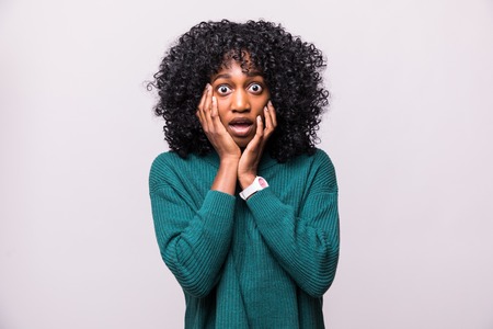 Portrait of scared young african woman female with curly hairstyle shocked isolated on white backgroundの写真素材