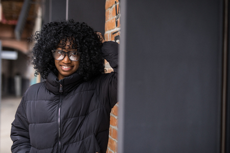 Young cool black skin girl walking in the street.の写真素材