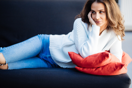 Young smile woman relaxing on her couchの写真素材