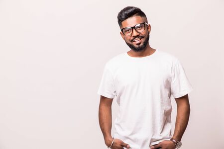 Young indian man in eyeglasses standing isolated on white backgroundの写真素材