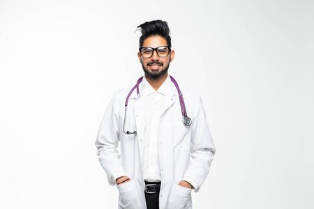 Male Indian doctor wearing a white coat and stethoscope. Isolated on white background.の写真素材
