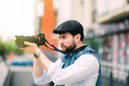 Portrait of happy, smiling man, tourists with camera in the city.の販売画像