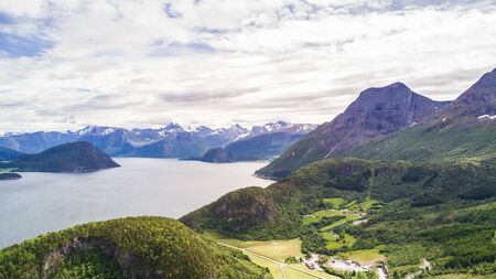 Norwegian aerial landscape: aerial view over the sea and snowy mountains, Norwayの写真素材