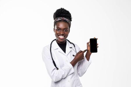 Young doctor woman pointing on cellphone screenの写真素材