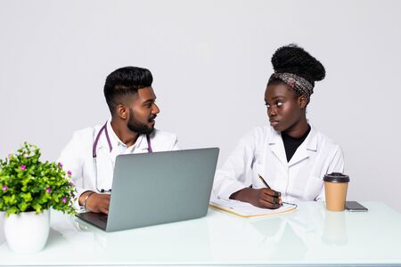 Photo of two doctors together discussing new way of treatment while having a meeting at office.の写真素材