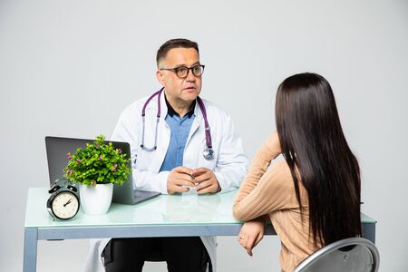 Man Doctor with female patient at consultation. Healthcare.の写真素材