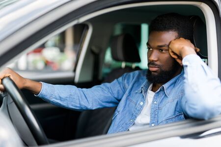 Portrait of an handsome smiling business man driving his carの写真素材