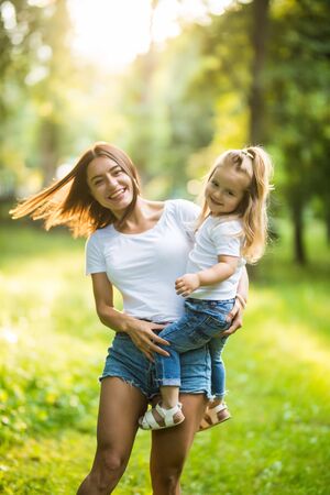 Attractive Mother and daughter spending time together in the parkの写真素材
