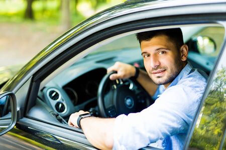 Young man sitting in a carの写真素材