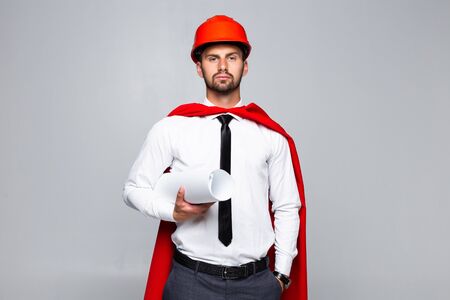 Young architect with blank and hemlet looks like superhero on white backgroundの写真素材