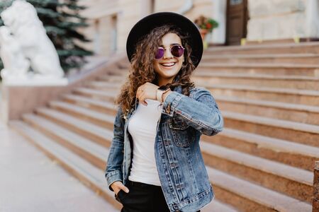 Portrait smiling woman with smart watch using voice command recorder or takes calling on city streetの写真素材